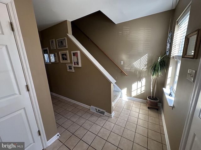 stairway featuring tile patterned floors