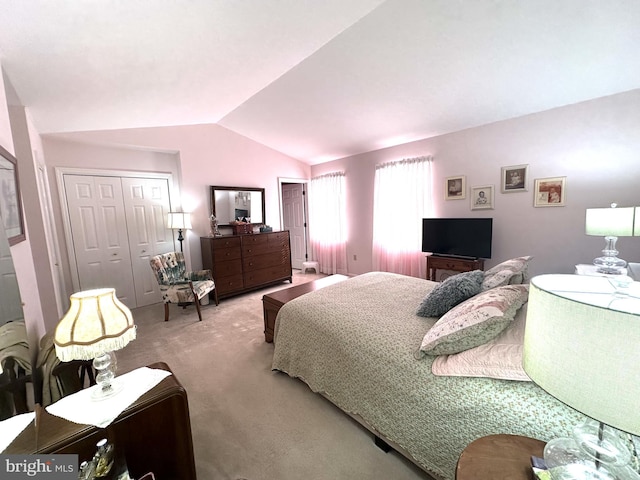 bedroom with carpet floors and vaulted ceiling