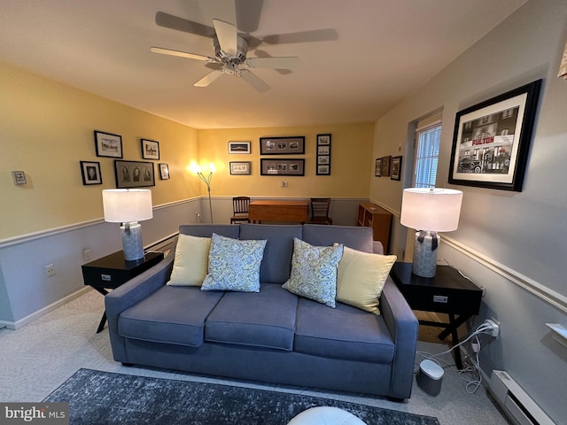 living room featuring baseboard heating, ceiling fan, and carpet floors