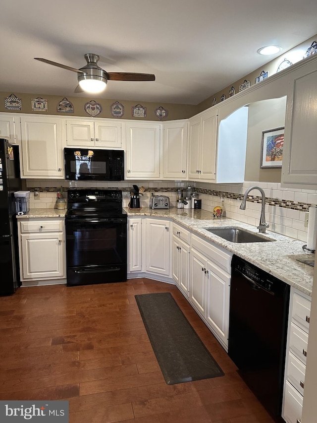 kitchen with sink, white cabinetry, black appliances, dark hardwood / wood-style flooring, and decorative backsplash