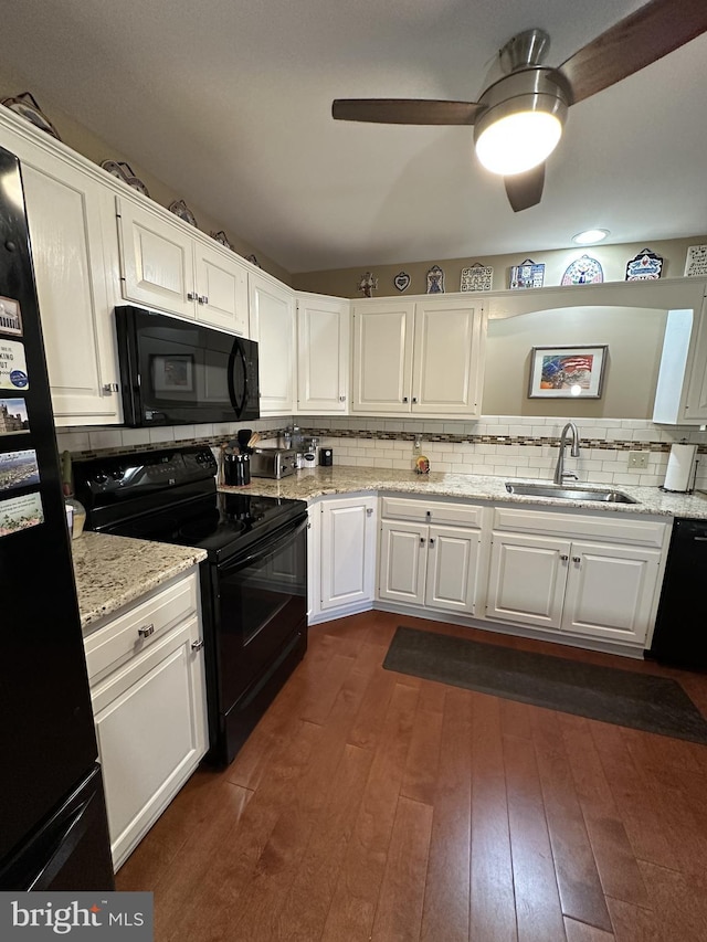 kitchen with white cabinetry, sink, decorative backsplash, and black appliances