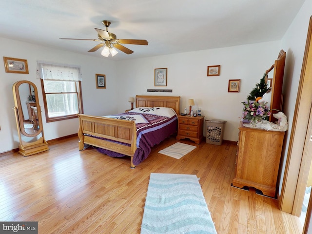 bedroom with baseboards, a ceiling fan, and light wood-style floors