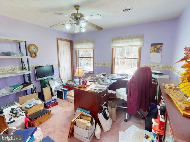 office with visible vents, a ceiling fan, and light colored carpet