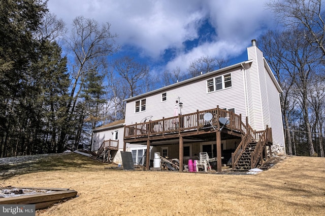 back of house with stairs, a chimney, a deck, and a yard