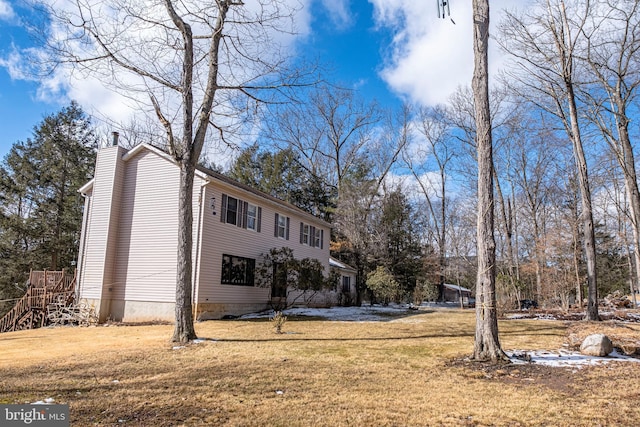 view of front of house with a front yard and a chimney