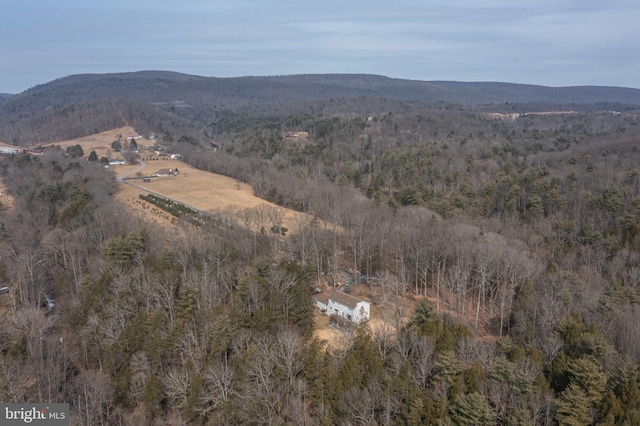 birds eye view of property featuring a mountain view and a wooded view