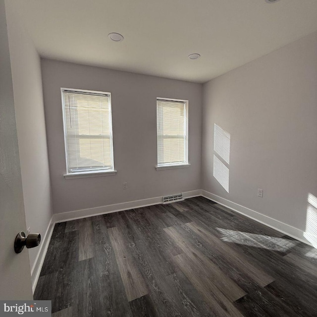 unfurnished room featuring dark hardwood / wood-style floors