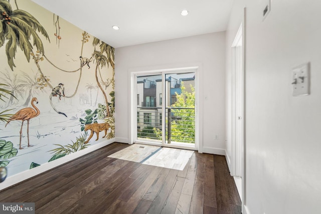 entryway with dark wood-style floors, an accent wall, recessed lighting, and baseboards