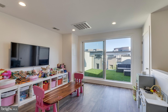 recreation room with recessed lighting, visible vents, and wood finished floors