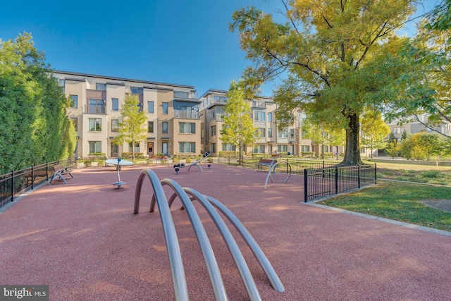 view of home's community featuring fence and a lawn