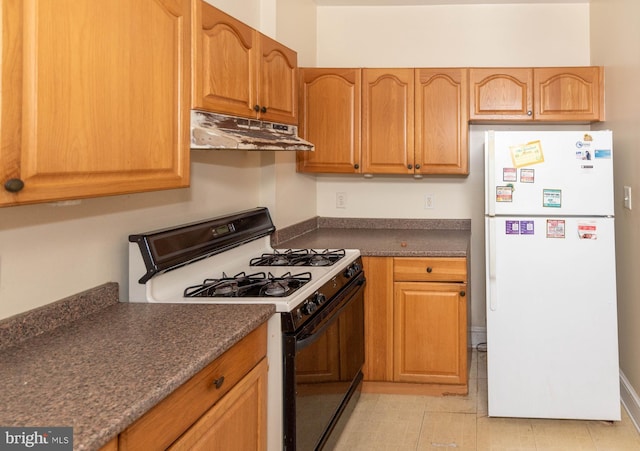 kitchen with white refrigerator and range with gas cooktop