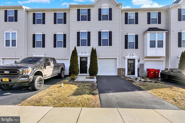 view of property featuring driveway and a garage