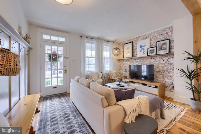 living room with crown molding and light wood-type flooring