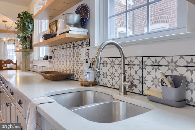 kitchen featuring sink and a chandelier