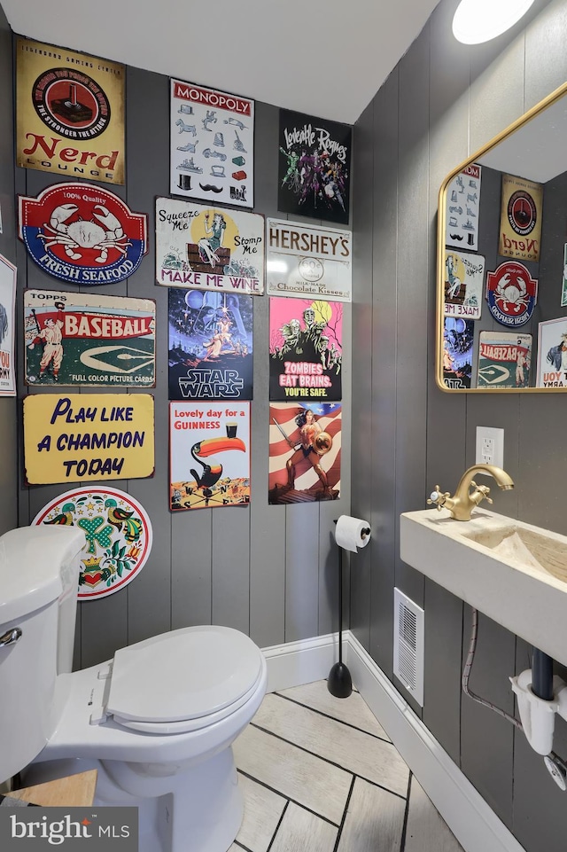 interior space with tile patterned floors and toilet