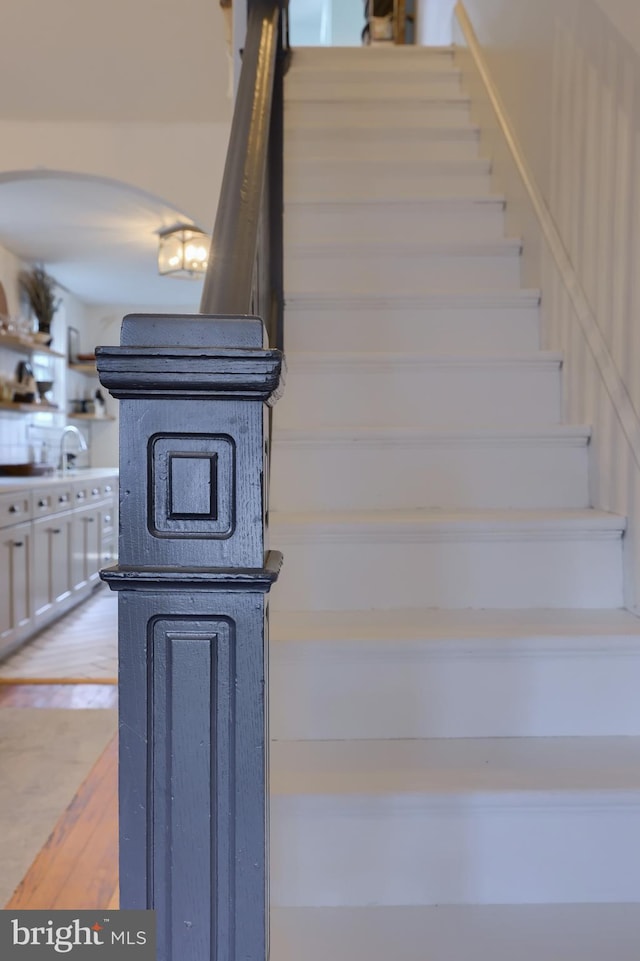 stairs featuring hardwood / wood-style flooring