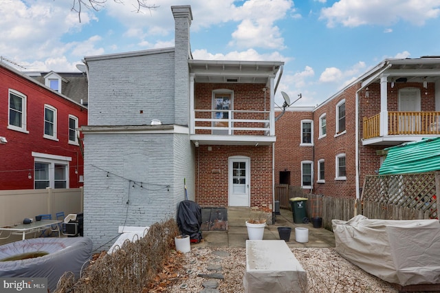 back of house featuring a balcony