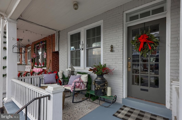 view of exterior entry with covered porch