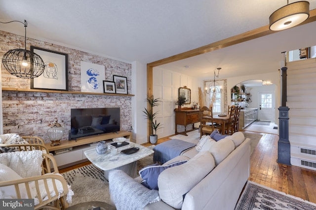 living room featuring an inviting chandelier and hardwood / wood-style floors