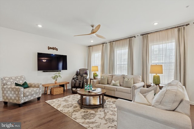 living room with ceiling fan and dark hardwood / wood-style flooring