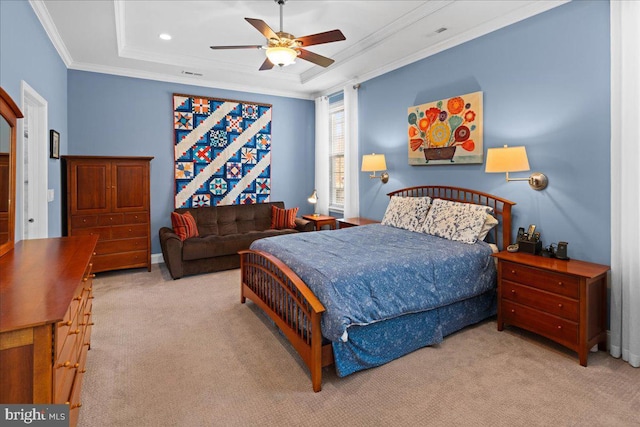 bedroom featuring light carpet, a tray ceiling, ornamental molding, and ceiling fan