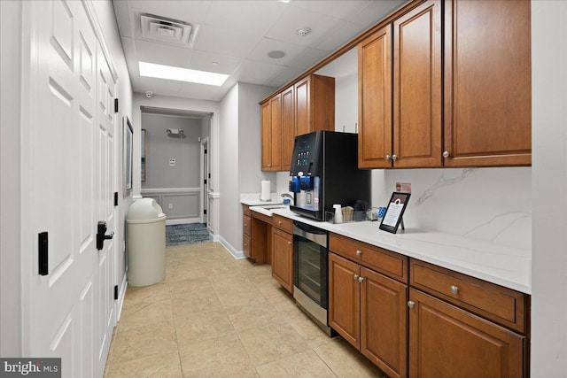 kitchen with tasteful backsplash and a paneled ceiling