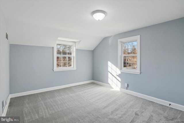 bonus room featuring lofted ceiling and carpet