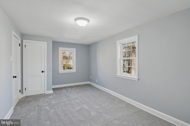 unfurnished room featuring light colored carpet