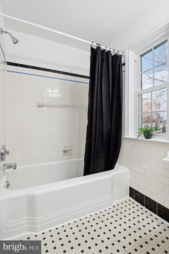 bathroom with tile patterned floors and shower / bath combo with shower curtain