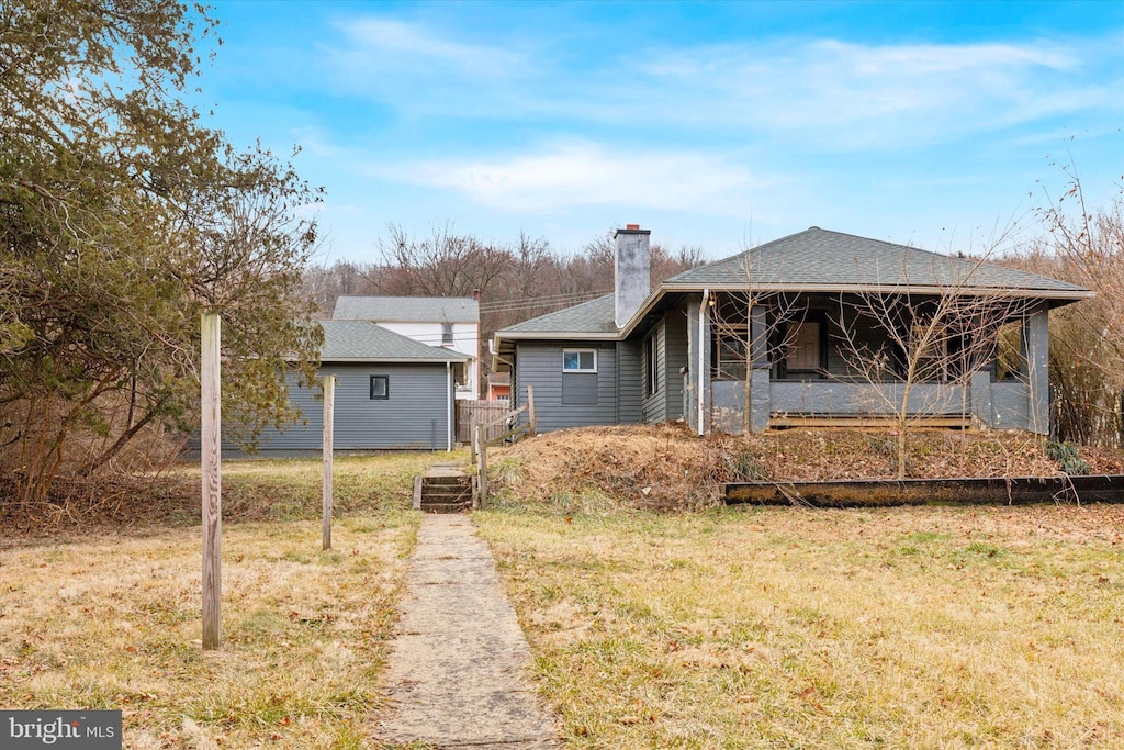 back of property featuring a yard