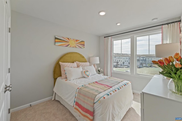 bedroom featuring light carpet