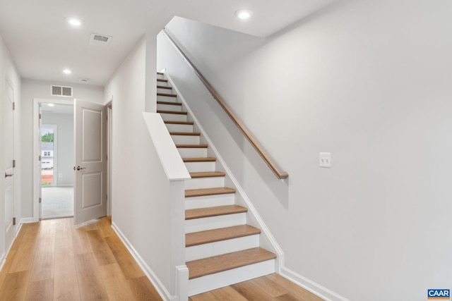 staircase with wood-type flooring