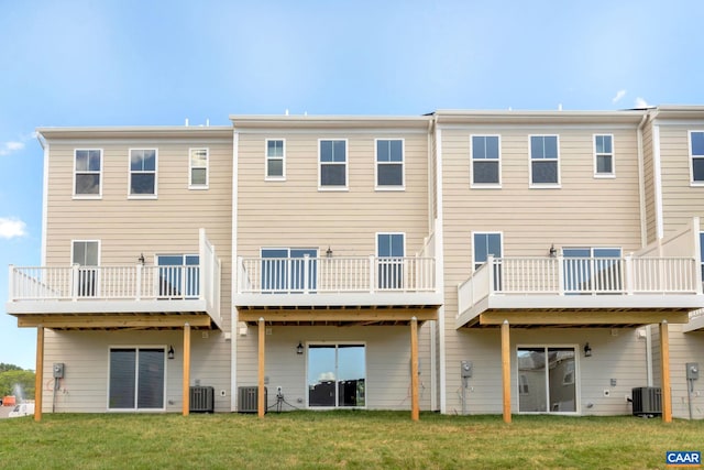 back of house featuring central AC unit and a yard