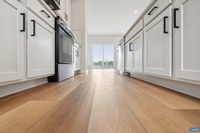 hall with light wood-type flooring