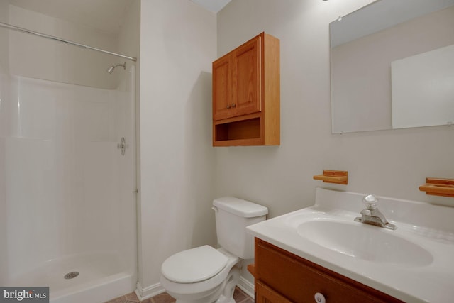 bathroom with vanity, toilet, and a shower