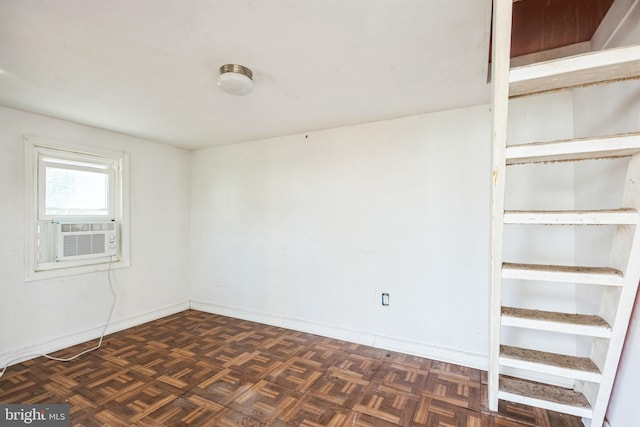 spare room with cooling unit and dark parquet flooring