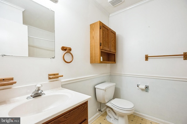 bathroom featuring vanity, crown molding, and toilet