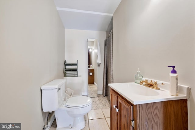 bathroom featuring tile patterned flooring, vanity, and toilet