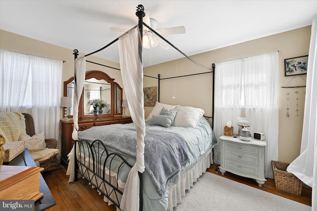 bedroom with hardwood / wood-style floors and ceiling fan