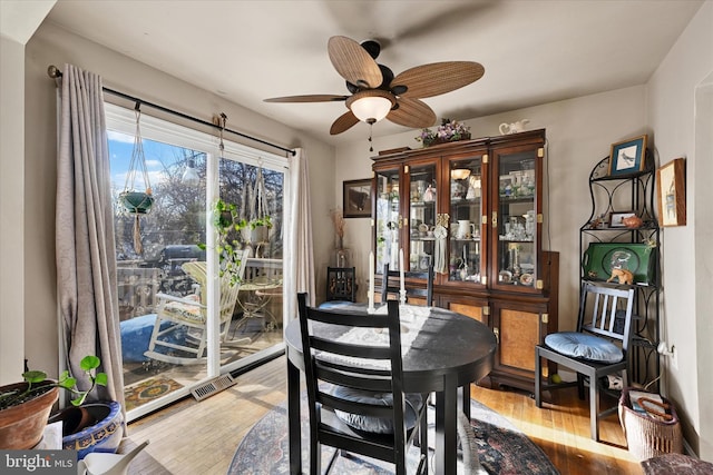 dining area with ceiling fan and hardwood / wood-style floors