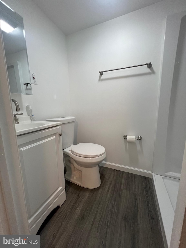 bathroom with vanity, hardwood / wood-style floors, and toilet