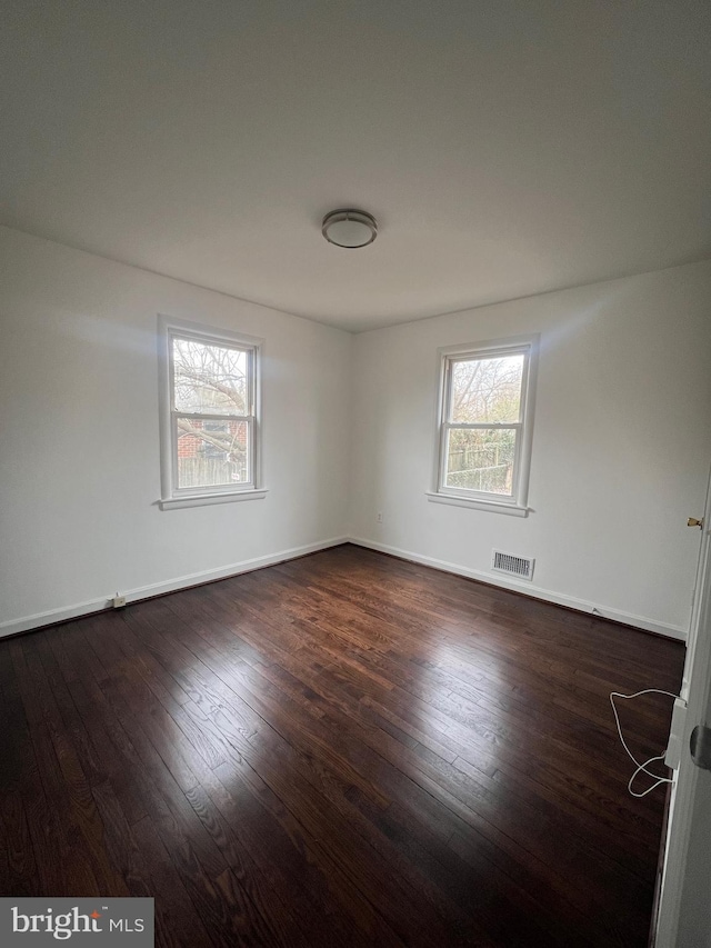 empty room with dark hardwood / wood-style floors