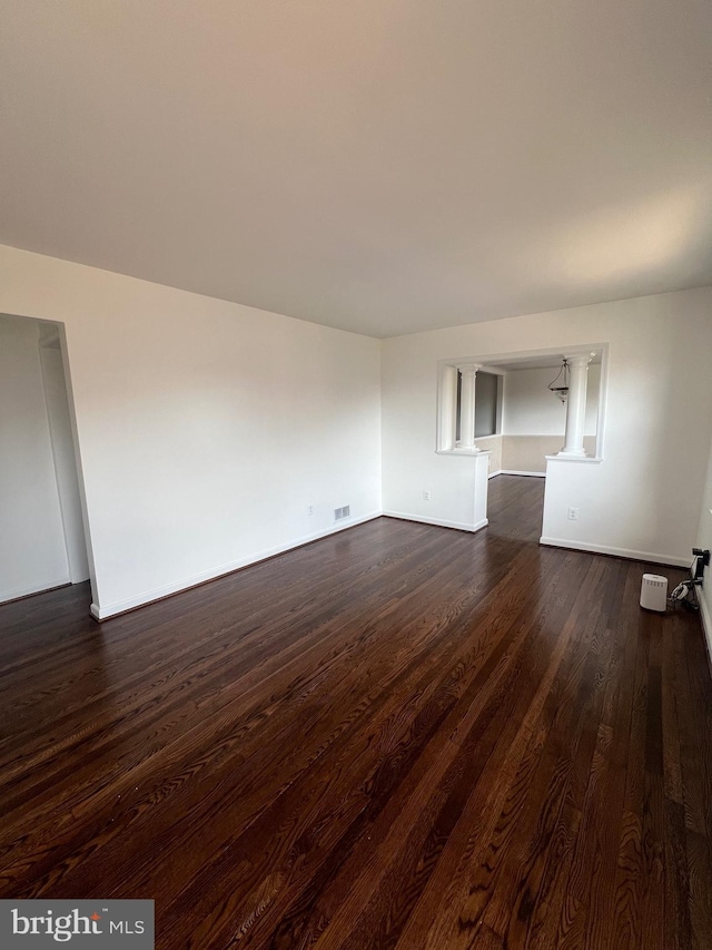 unfurnished room featuring dark wood-type flooring