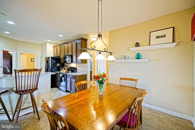 dining space featuring baseboards and recessed lighting