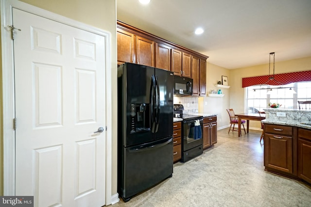 kitchen with light floors, baseboards, backsplash, black appliances, and pendant lighting