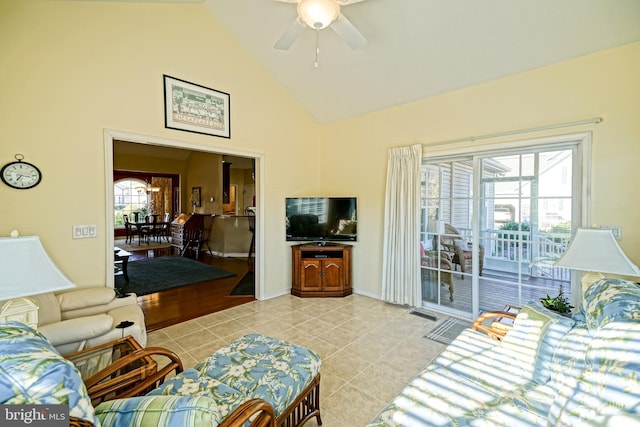 living room featuring baseboards, high vaulted ceiling, a ceiling fan, and light tile patterned flooring