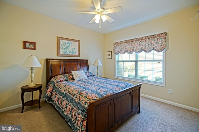 bedroom featuring ceiling fan, baseboards, and light colored carpet