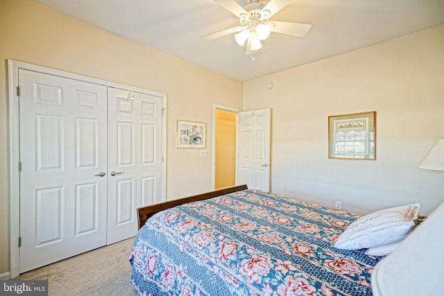 carpeted bedroom with a ceiling fan and a closet