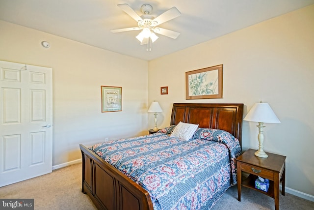 bedroom with ceiling fan, baseboards, and light colored carpet