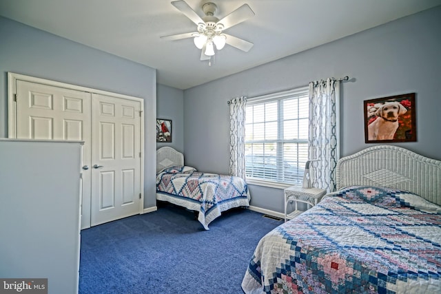 bedroom featuring a closet, dark carpet, a ceiling fan, and baseboards